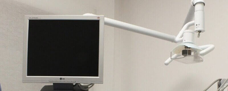 Photo of a dermatological procedure for skin tag removal using surgical instruments
